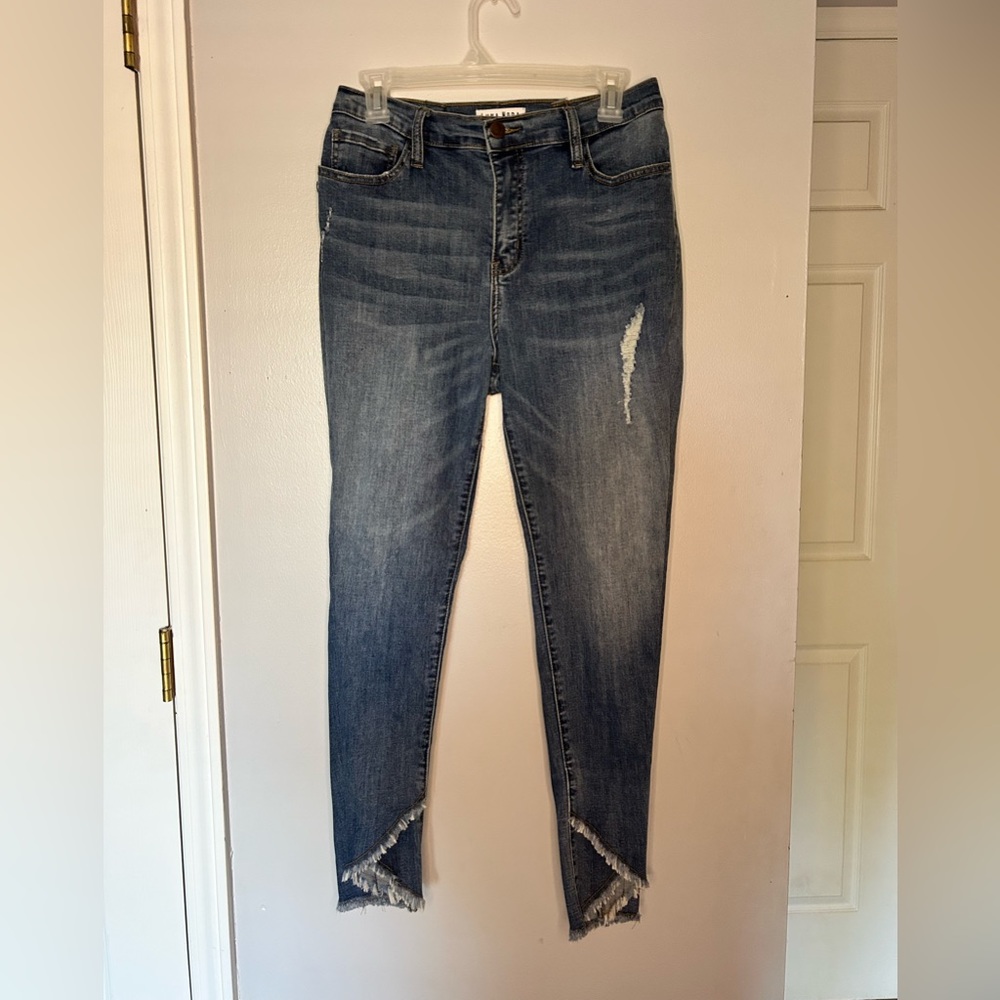 Skinny jeans with a design at the ankles and a little ripped on one side.